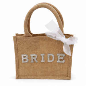 Personalised bride jute tote bag with rhinestone “BRIDE” lettering and white bow on a clean white background